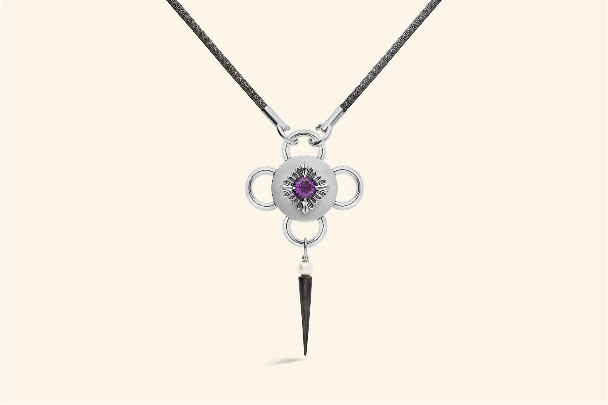 Bolt necklaceThis ~2.50 carat amethyst is set with a polished blackened silver flower, itself set on a satin-finish silver disk . Akoya bead. Knitted chain in blackened silver. 