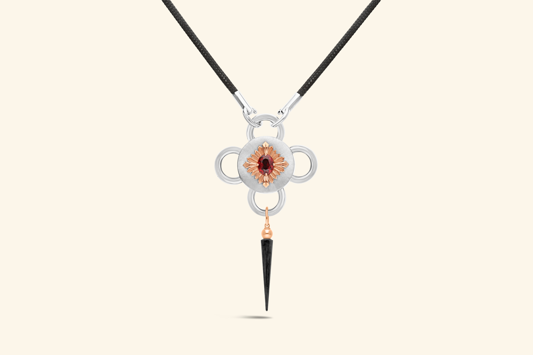Bolt necklaceA ~1.79-carat rubellite set with a polished rose gold flower on a satin-finish silver disk . A tassel in rose gold and blackened silver. Knitted chain in blackened silver.